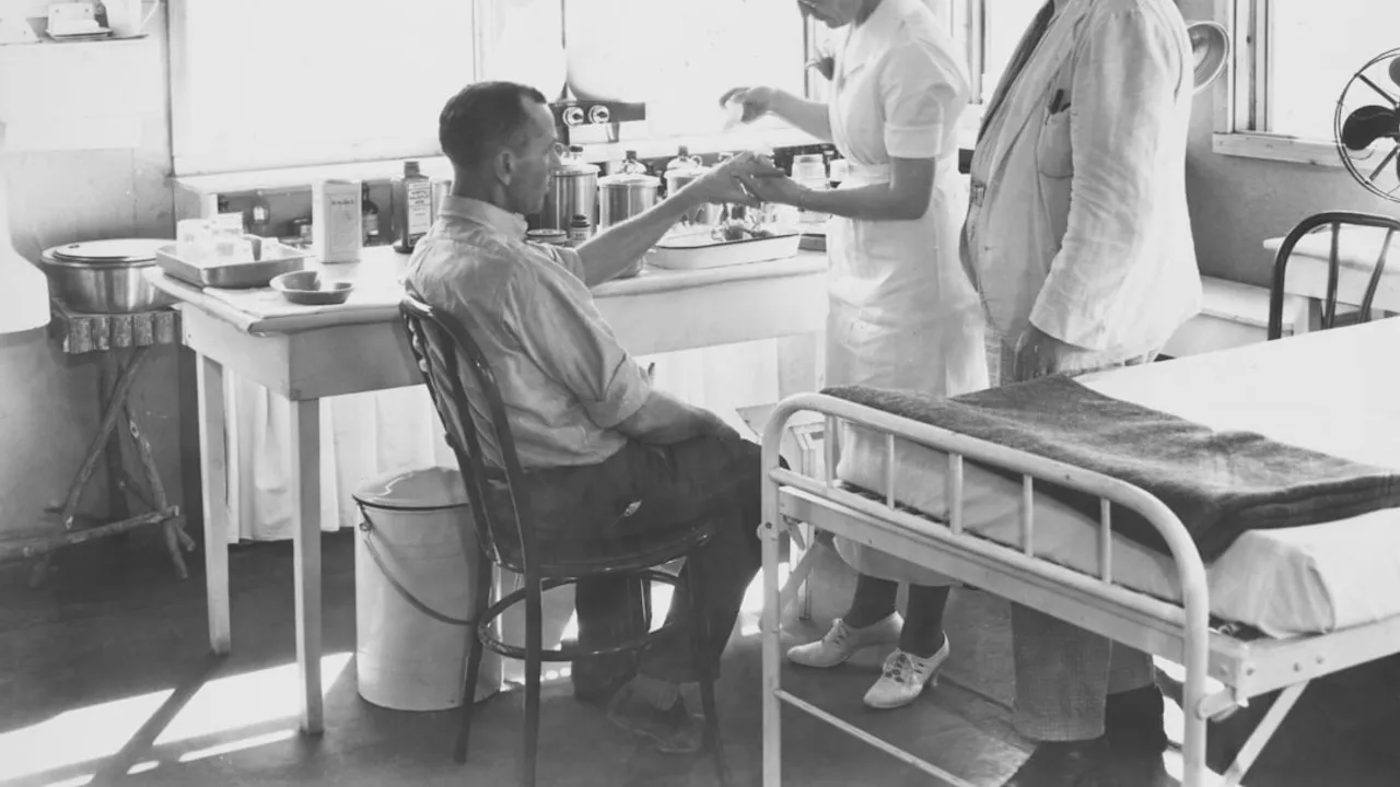 Nurse attends to patient with doctor observing